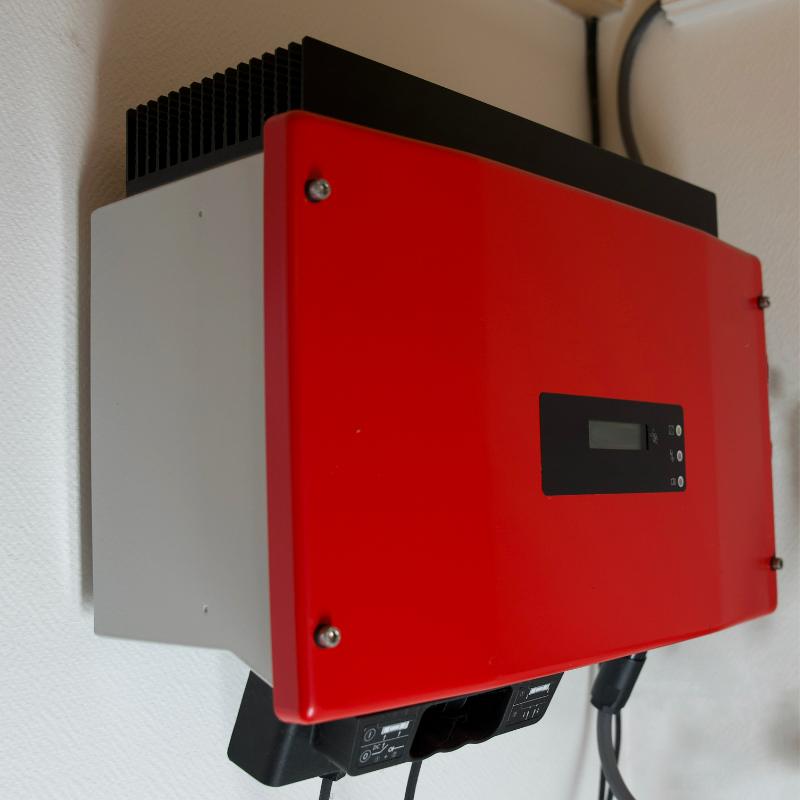 red solar inverter on wall