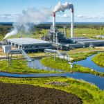 An imaginative depiction of biomass and waste sources, including agricultural, municipal, and forestry waste, being utilized in a sleek energy plant, representing Australia's transition to sustainable energy.